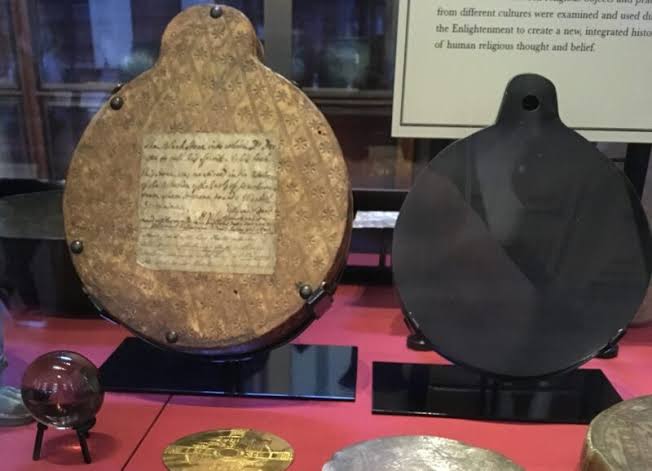 John Dee’s obsidian mirror and the wax Sigillum Dei Aemeth, as displayed in the British Museum.